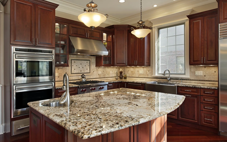 Marble-topped kitchen island in a wide authentic kitchen