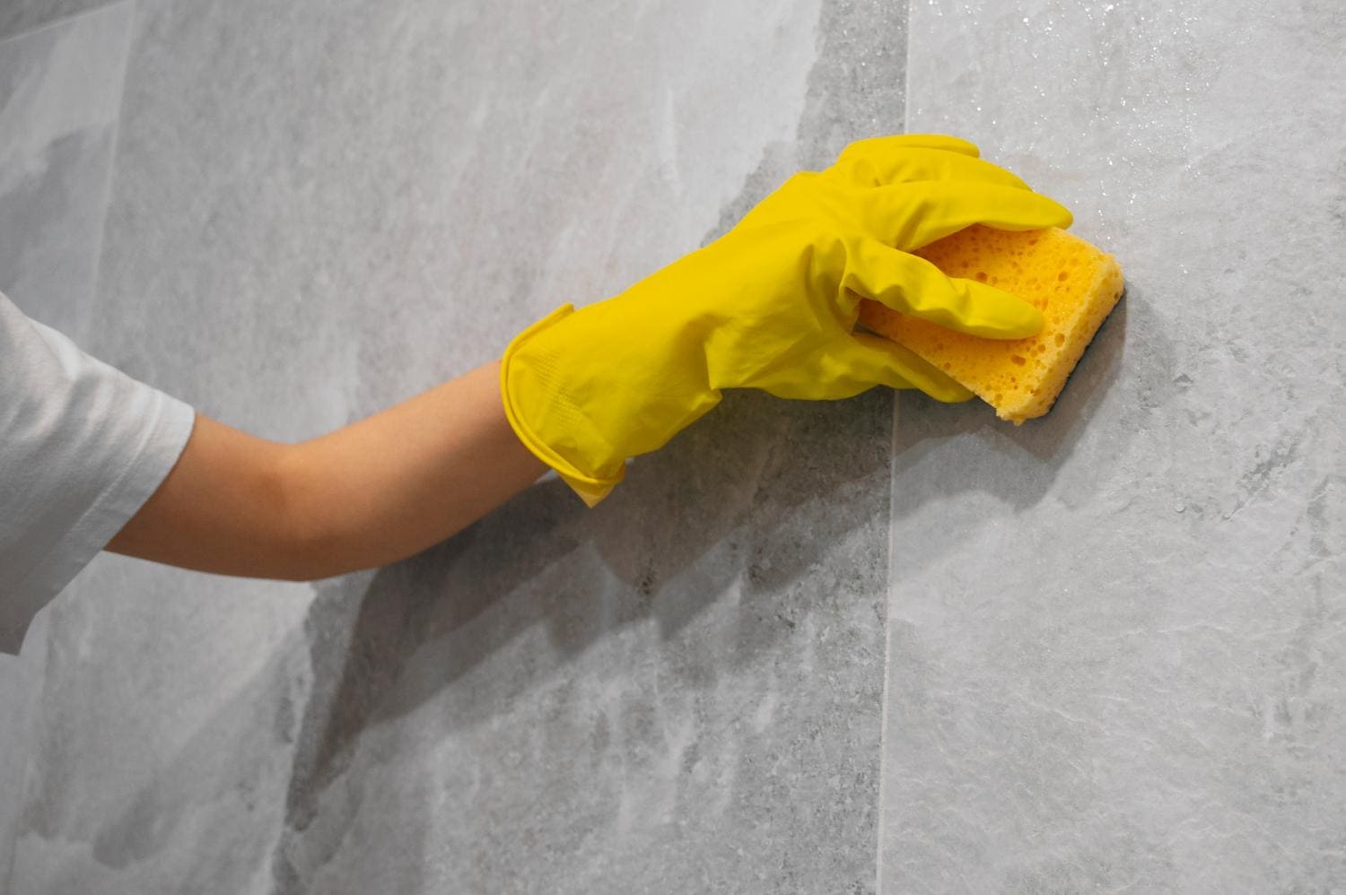Cleaning granite surface with a sponge